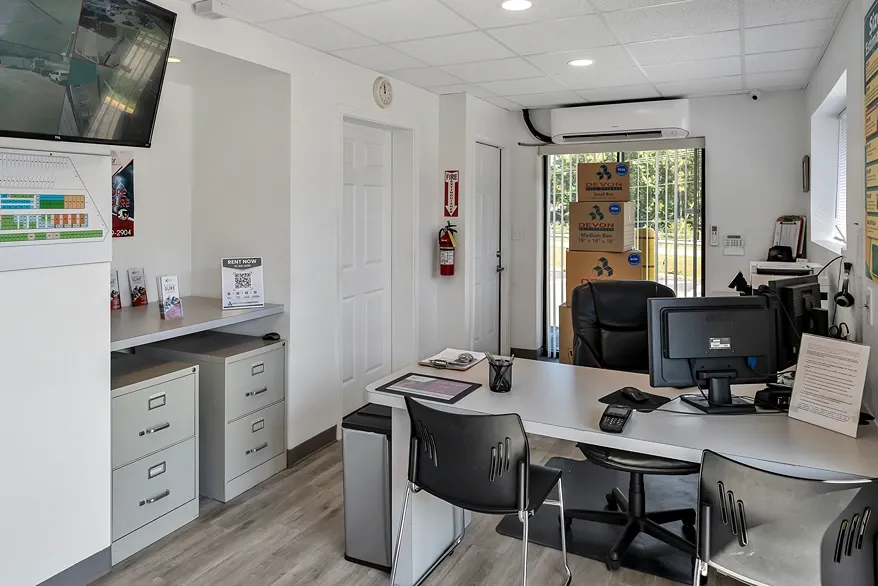 Self storage office interior with customer service desk and security monitoring